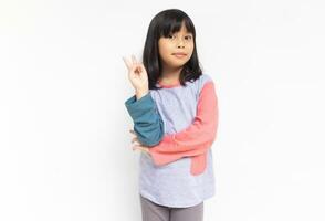 A cute confident girl raised her hand to showing sign gesture with fingers photo