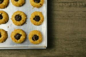 Cheese Thumbprint Cookies with Chocolate Filling, thumbprint cookies fresh from the oven on the aluminum pan photo