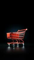 Black background with an isolated shopping cart. photo