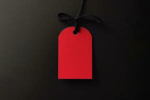 Red empty price tag on black or dark background. Black Friday concept, template copyspace photo