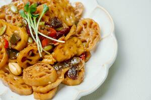 korean food yeongeunjorim, Braised Lotus Roots, Yeongeun parboiled and braised in a mixture of soy sauce and sugar over lower heat. Add syrup and braise to a glaze before serving. photo