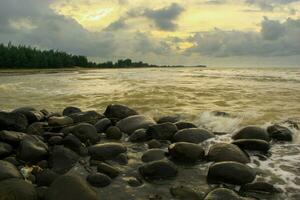 Sunset landscape over the beautiful rocky coastline in the Sea. photo