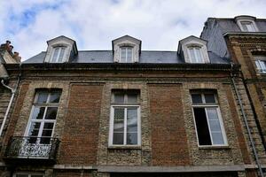 a building with three windows and a balcony photo