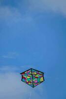 a colorful kite in the blue sky photo