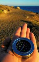 a compass is held in the hand of a person photo