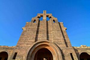 the entrance to a church with arches and a cross photo