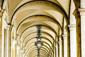 a long row of arches with light fixtures photo