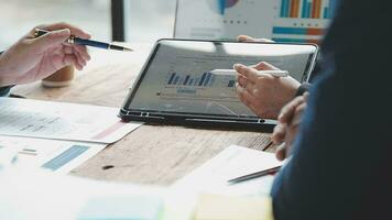Teamwork with business people analysis cost graph on desk at meeting room. double exposure successful teamwork,business planning concept. video