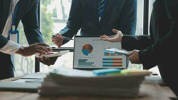 Teamwork with business people analysis cost graph on desk at meeting room. double exposure successful teamwork,business planning concept. video