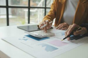 Accounting businessman working on laptop computer and analyzing real estate investment data, Financial and tax systems concept. photo