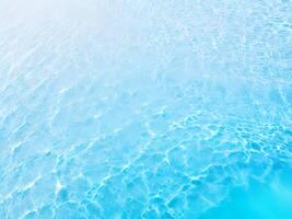 texture of Water Ripple reflections on light blue bottom. surface of blue swimming pool. abstract water background with copy space for any purpose. Top view. photo