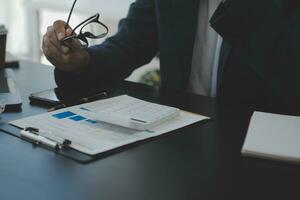 Business Documents, Auditor businesswoman checking searching document legal prepare paperwork or report for analysis TAX time,accountant Documents data contract partner deal in workplace office photo