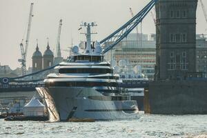 Cruise ship moored on Thames river with Tower bridge in background photo