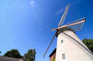 a windmill is shown against a blue sky photo