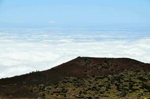 a view of the clouds from the top of a mountain photo