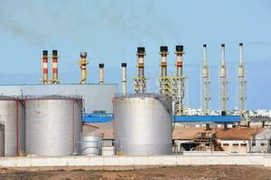 industrial plant with stacks of tanks and pipes photo