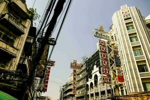 a city street with many buildings and signs photo