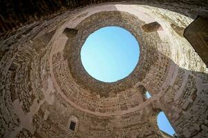 the inside of a stone building with a circular window photo