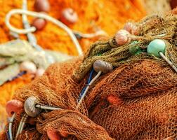 a close up of a bunch of orange and blue fishing nets photo