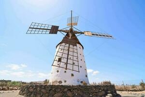 Traditional windmill in front of blue sky photo