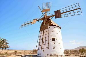 Traditional windmill in front of blue sky photo