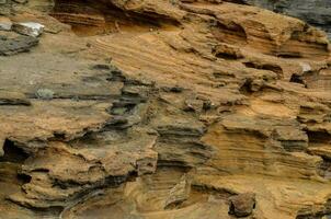 a rock formation with many different types of rocks photo