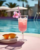 Pink cocktail with lemon wedge sitting on the pool table photo