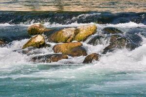 a river with rapids and rocks in it photo