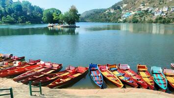 a row of colorful boats in the lake photo