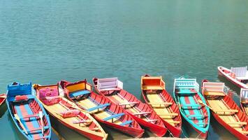 a row of colorful boats in the lake photo