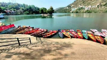 a row of colorful boats in the lake photo