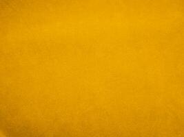 Yellow velvet fabric texture used as background. Empty yellow fabric background of soft and smooth textile material. There is space for text. photo