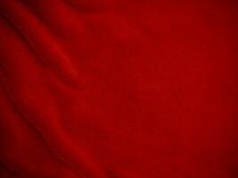 red clean wool texture background. light natural sheep wool. scarlet seamless cotton. texture of fluffy fur for designers. close-up fragment red wool fabric carpet. photo