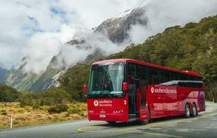 Fiordland national park, New Zealand -September-30-2017 - Tour bus park in Monkey Creek a beautiful spot on the road to Milford Sound in South Island of New Zealand. photo
