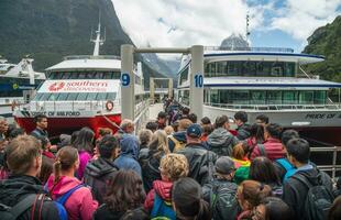 Milford Sound, New Zealand -September-30-2017 - Many tourist waiting to get in the scenic boat cruises before travel in Milford Sound, New Zealand. photo