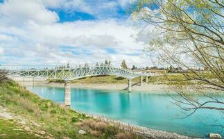 Scenery view of Lake Tekapo footbridge across the stunning water of lake Tekapo in South Island, New Zealand. photo