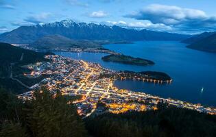 The spectacular view of Queenstown one of the most beautiful town in South Island of New Zealand view from the top of Queenstown skyline on Bob's peak at dusk. photo