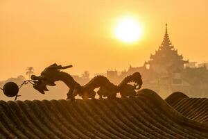 Sunrise over the dragon statue in Kandawgyi lake of Yangon township of Myanmar. photo