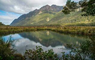 The spectacular landscape of Mirror lakes, the small lakes on the roadside provide outstanding reflective views of the Earl Mountains in south island of New Zealand. photo