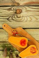 beautiful colorful autumn pine cone and pumpkin on wooden background. photo