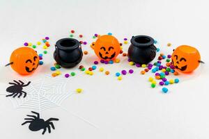 Halloween, pumpkins, bat silhouettes, spider web silhouette and paper spiders, on white background. Selective focus. photo