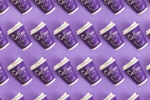 Top view of disposable coffee cups. Paper cups. On pastel violet background photo