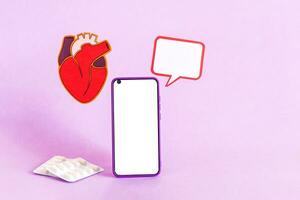 Smart phone and heart health insurance, world heart day, world health day. photo