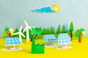 Sustainable power from solar panels and wind turbines, paper cut, paper art. photo