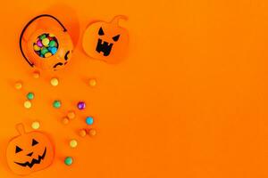 Halloween frame of scattered candy and decor. photo