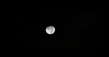 the moon is seen in the dark sky photo