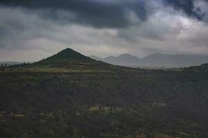 a view of a mountain range with dark clouds photo