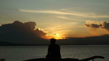 silhouette of man on the lake photo