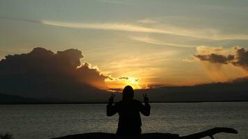 silhouette of man on the lake photo