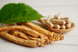 Ginseng roots and green leaf, healthy food. photo